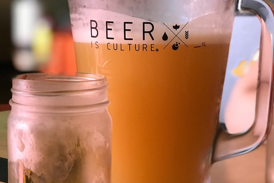 beverage filled pitcher beside empty jar