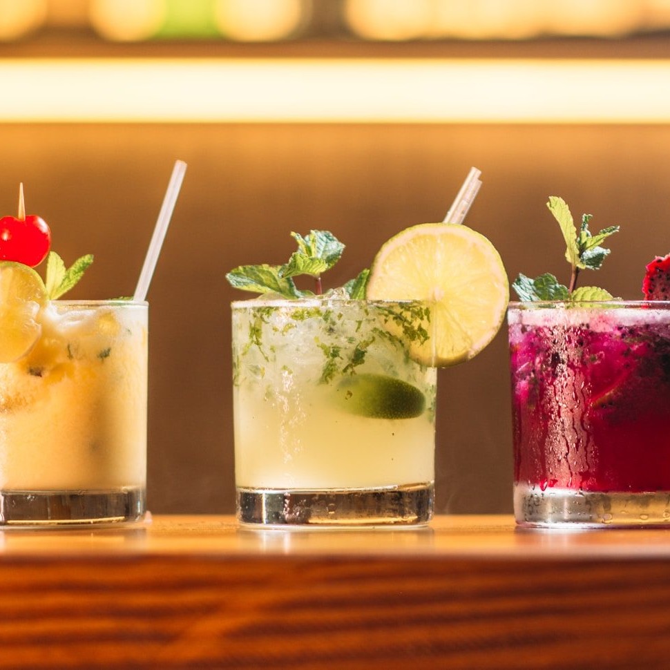 three clear glass cups with juice